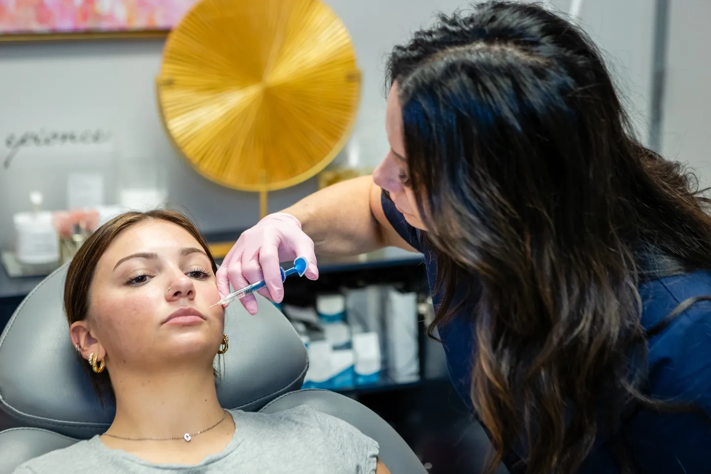 A woman is getting her hair cut by a stylist.