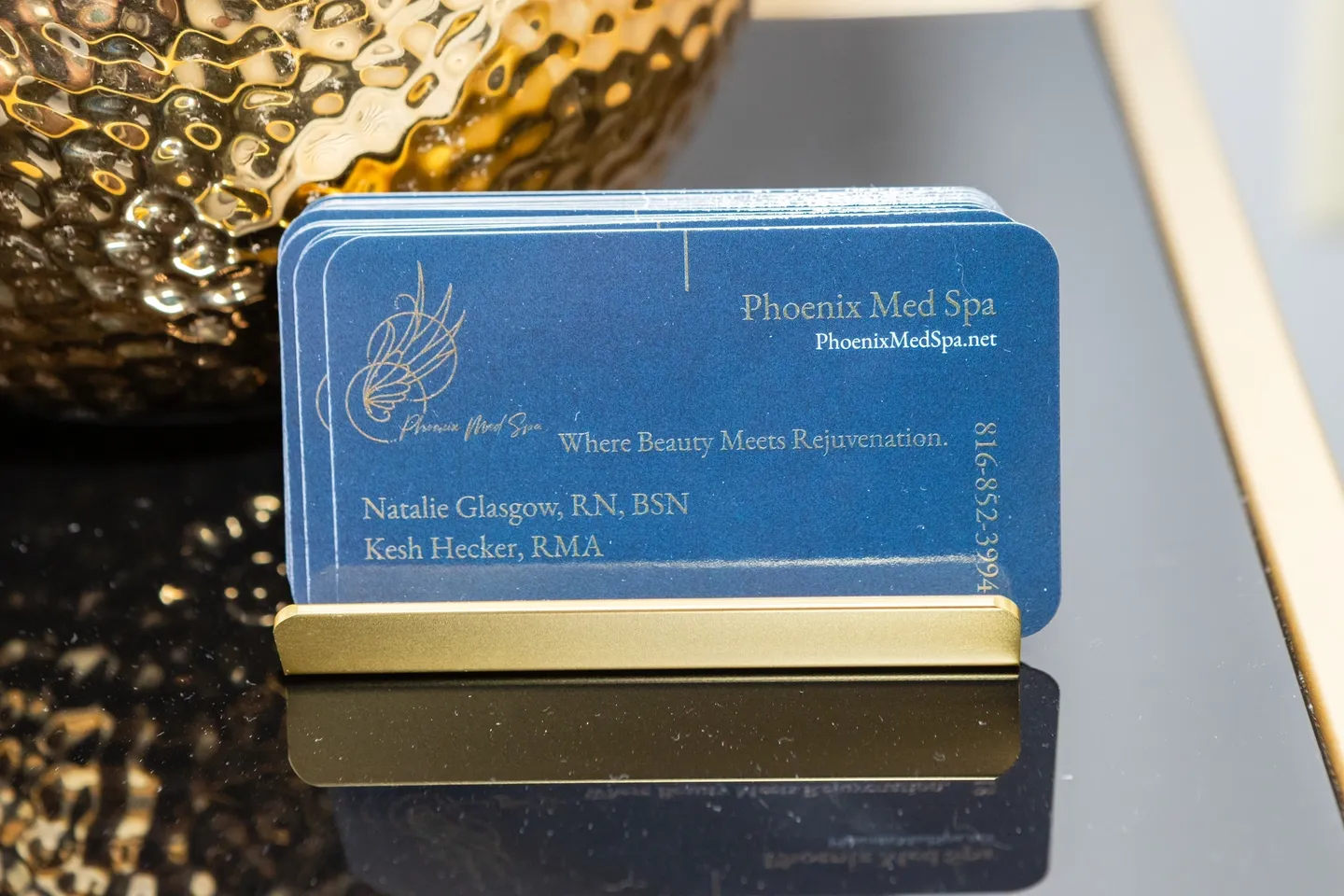 A business card holder is shown on top of a table.